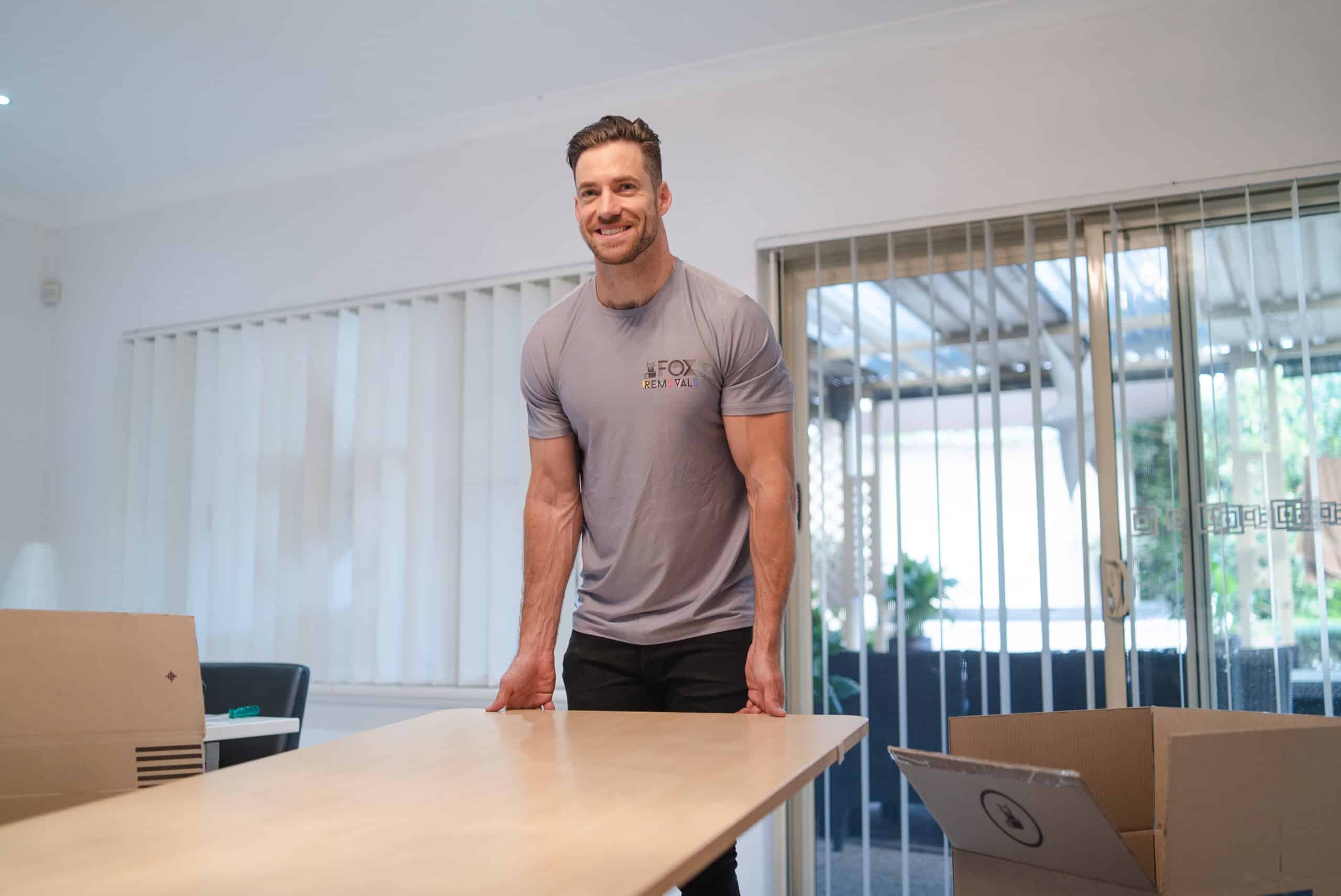 Fox Removals team member moving furniture in a house move