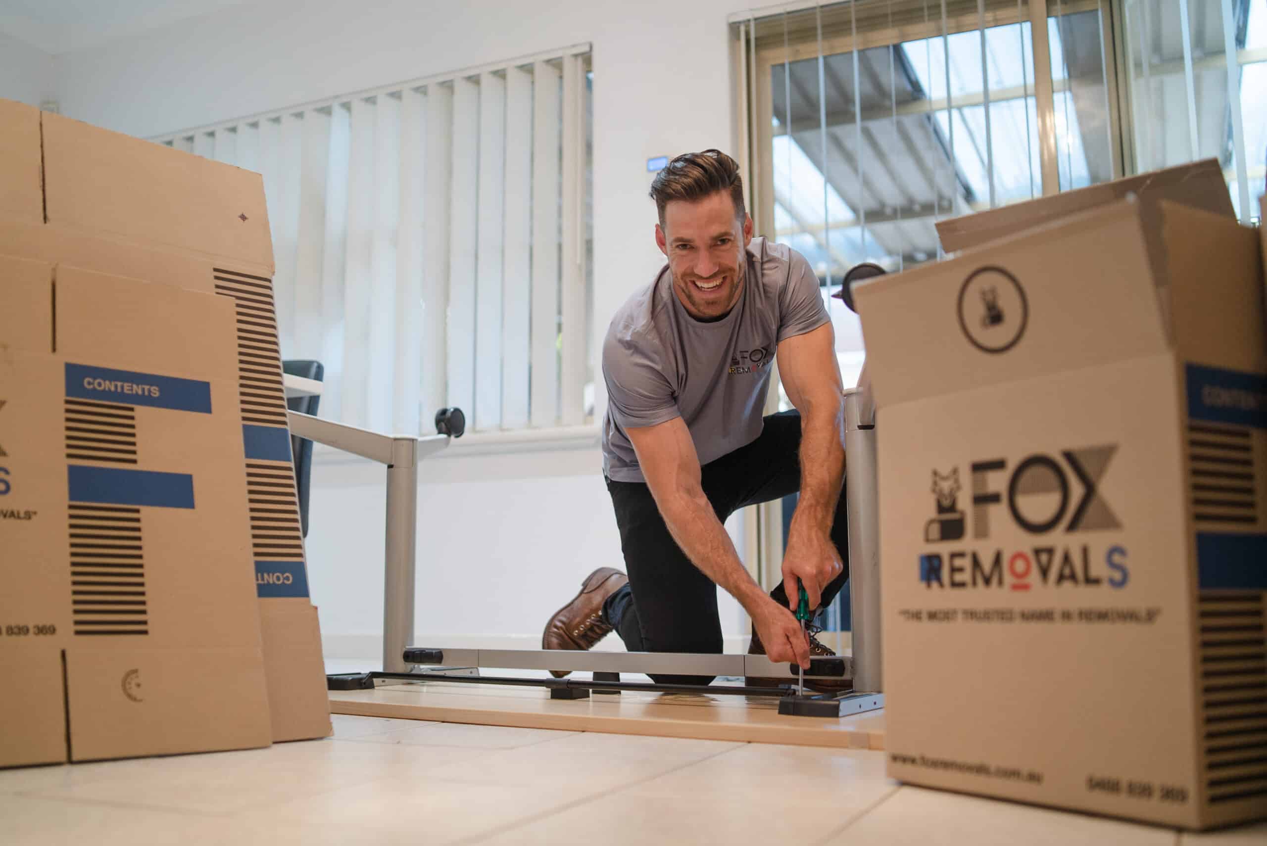 Fox Removals team member unassembling furniture